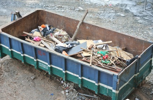 Overflowing commercial bin beside a loading bay